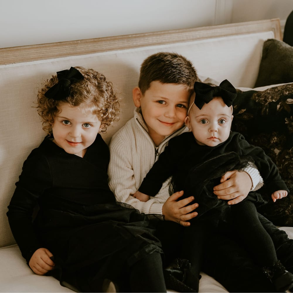 Three kids sitting on couch